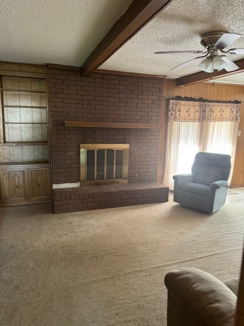 unfurnished living room featuring carpet, a brick fireplace, a textured ceiling, wood walls, and beamed ceiling