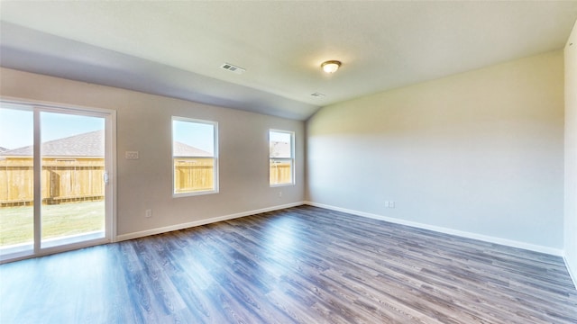 empty room featuring lofted ceiling and dark wood-type flooring