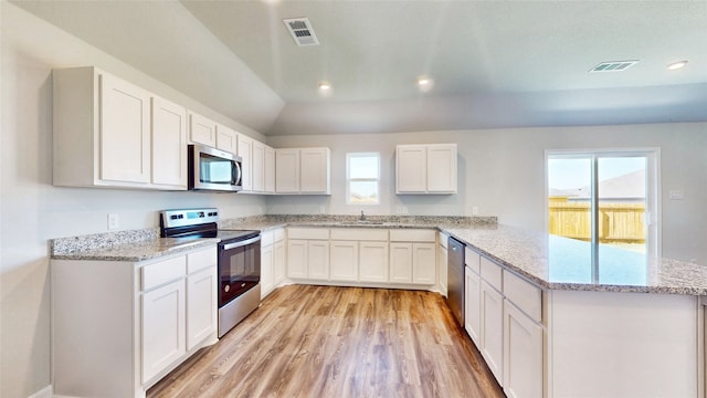 kitchen featuring sink, kitchen peninsula, white cabinetry, light hardwood / wood-style flooring, and appliances with stainless steel finishes