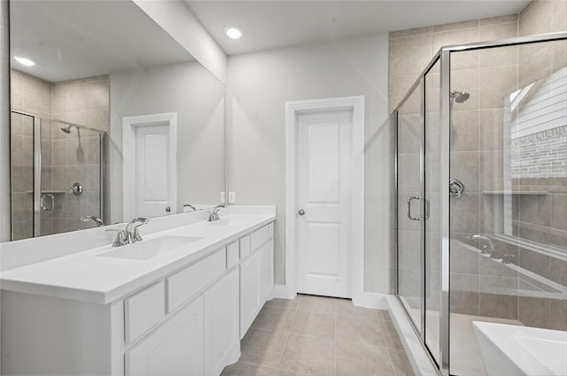 bathroom featuring walk in shower, tile patterned floors, and vanity