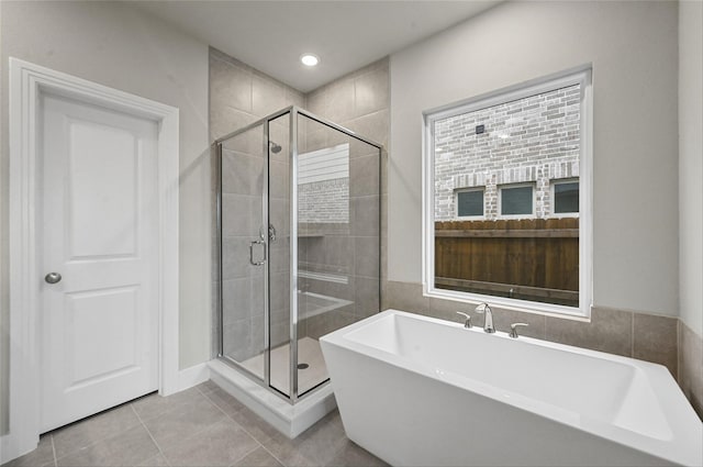 bathroom with plus walk in shower and tile patterned flooring