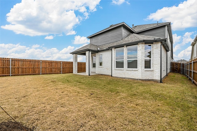 rear view of property featuring a lawn