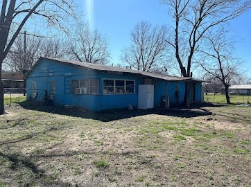 rear view of property featuring a yard