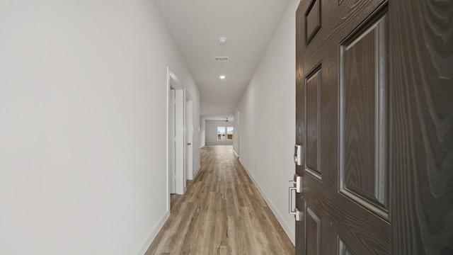 corridor featuring light hardwood / wood-style flooring