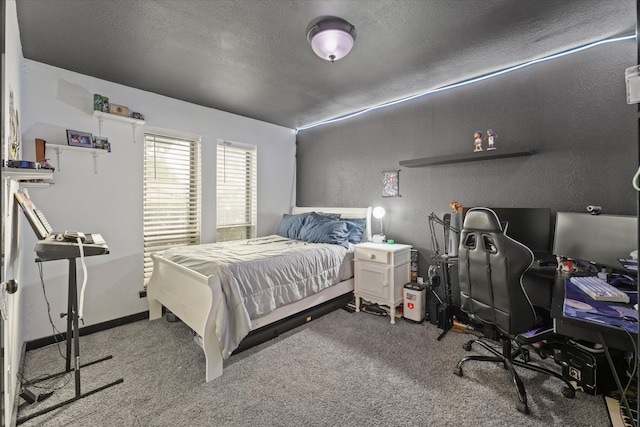 bedroom with a textured ceiling and carpet floors