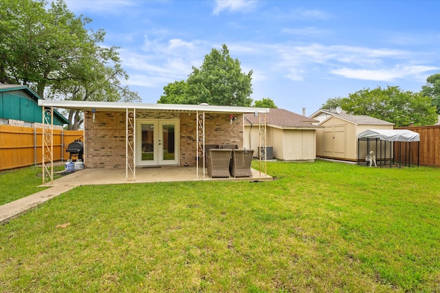 back of property featuring a storage shed, a patio area, french doors, and a lawn