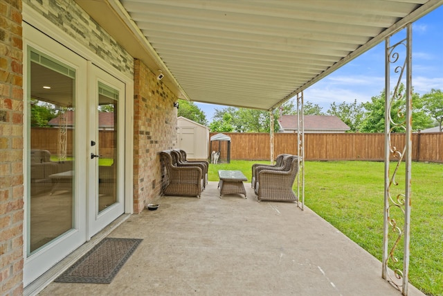 view of patio / terrace with a storage unit and french doors