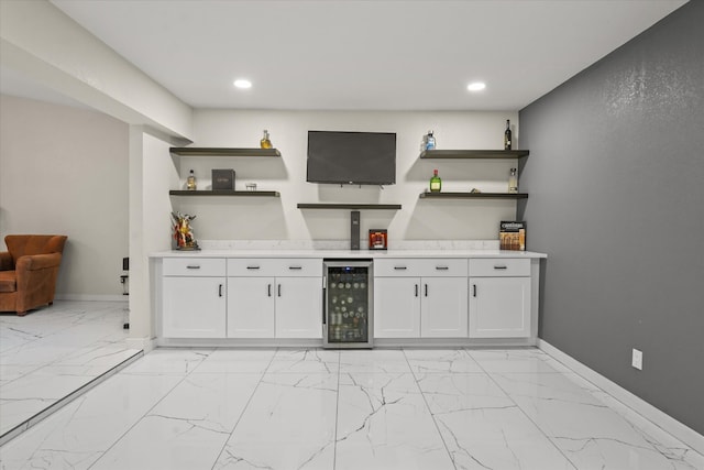 interior space with wine cooler, white cabinetry, and light tile floors