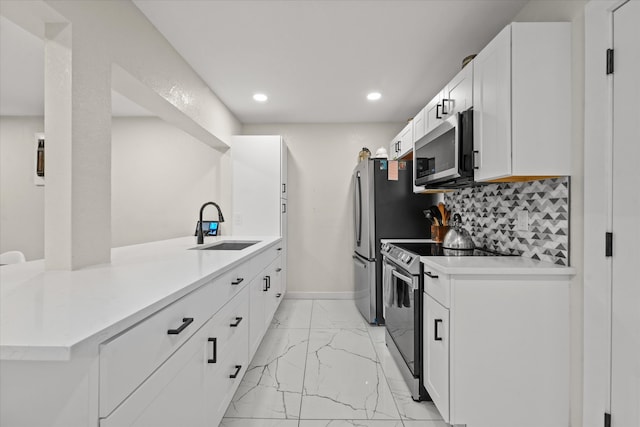 kitchen with light tile flooring, tasteful backsplash, white cabinets, sink, and appliances with stainless steel finishes