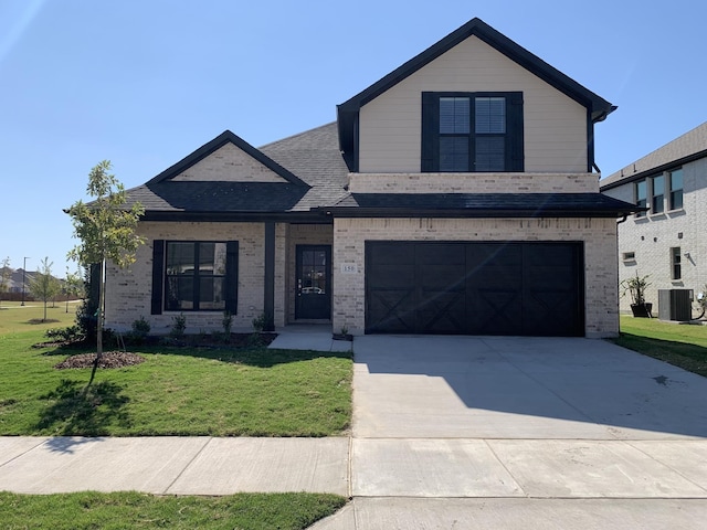 view of front of property with a front lawn, a garage, and cooling unit