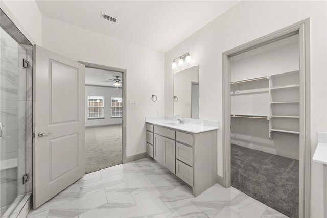 bathroom with ceiling fan, an enclosed shower, and vanity