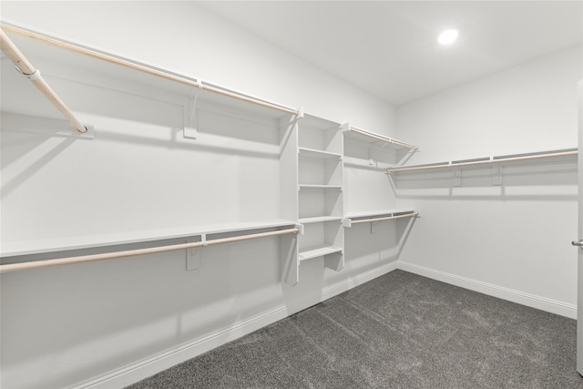 spacious closet featuring dark carpet