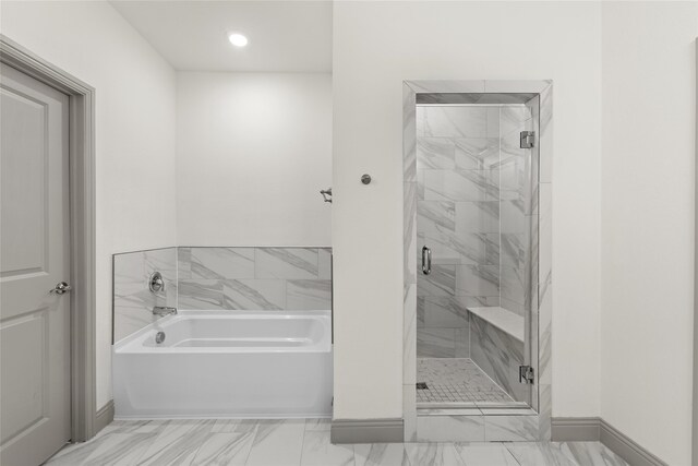 bathroom with shower with separate bathtub