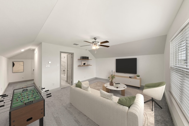 living room featuring ceiling fan, light colored carpet, and lofted ceiling