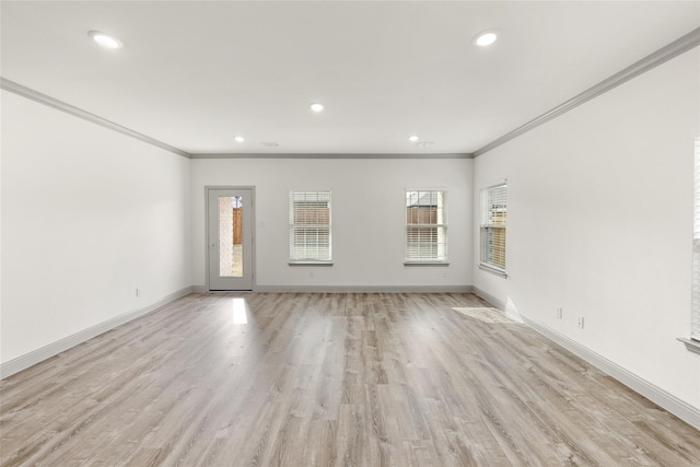 empty room with light hardwood / wood-style floors and ornamental molding