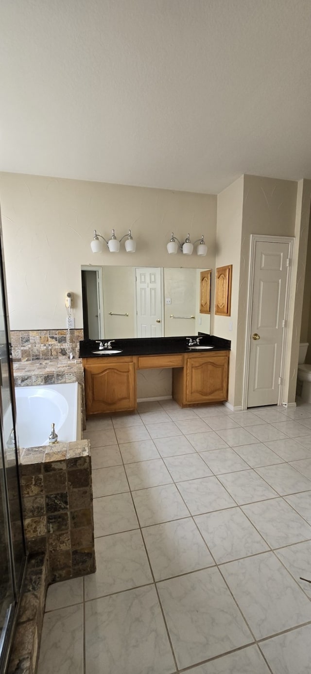 bathroom featuring double vanity, a sink, and a bath