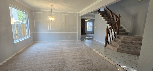 unfurnished dining area featuring light tile patterned floors, crown molding, baseboards, and stairs