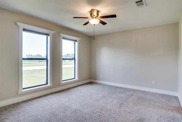 empty room featuring carpet flooring and ceiling fan