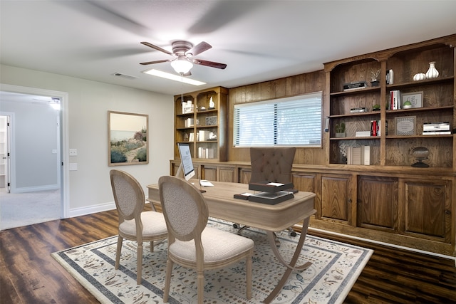 home office with ceiling fan and dark wood-type flooring