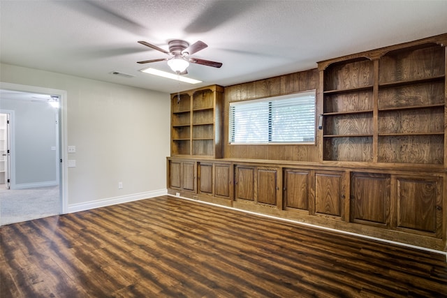 unfurnished living room featuring ceiling fan and a textured ceiling