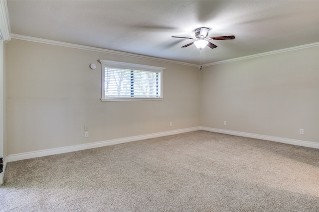 carpeted spare room with ceiling fan and ornamental molding