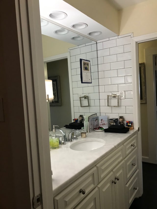 bathroom with decorative backsplash and vanity