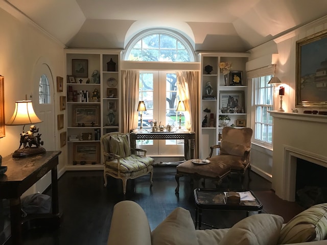 sitting room featuring a fireplace, crown molding, plenty of natural light, and vaulted ceiling