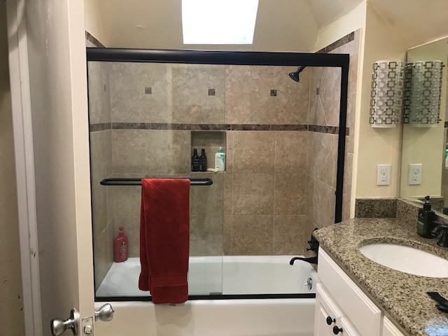 bathroom featuring vanity and enclosed tub / shower combo