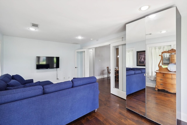 living room featuring dark wood-type flooring and french doors