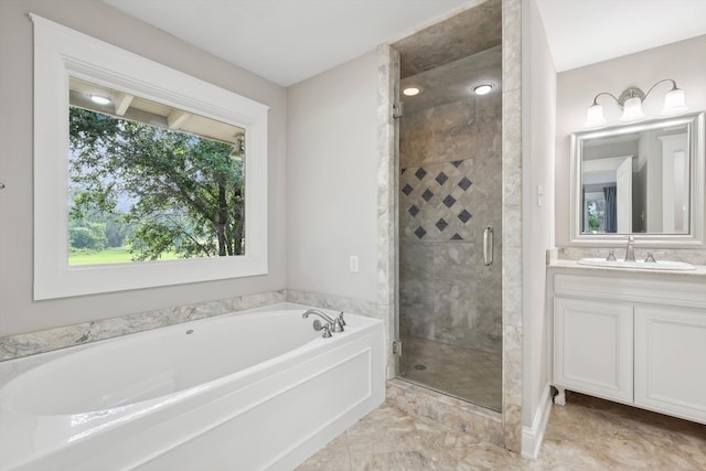 bathroom with vanity and shower with separate bathtub