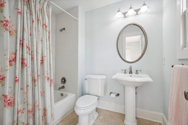 full bathroom featuring toilet, shower / bathtub combination with curtain, tile patterned floors, and sink