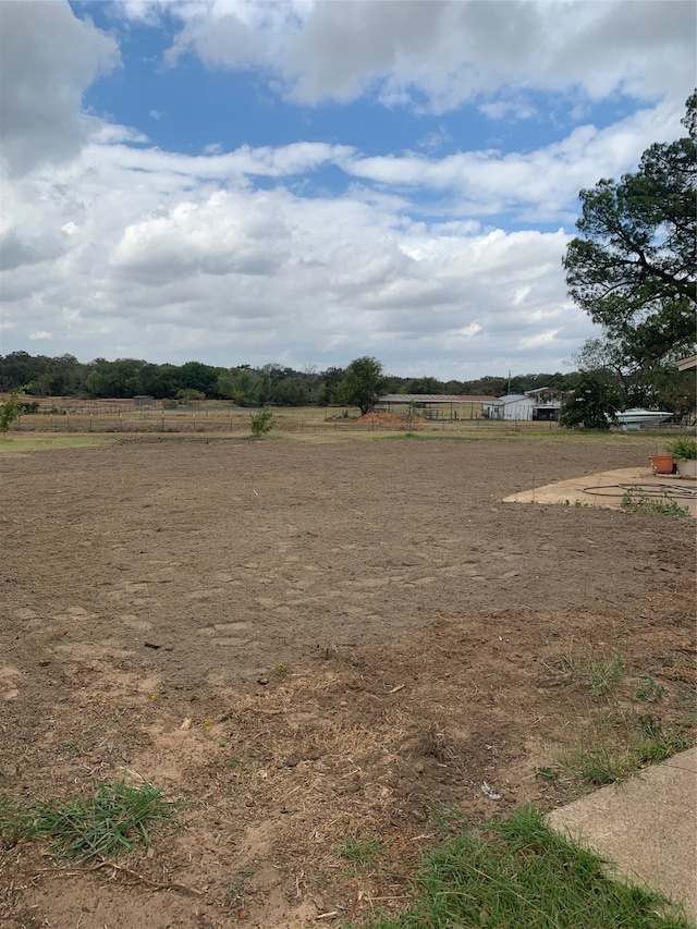 view of yard with a rural view