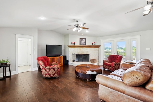 living room with a fireplace, french doors, ceiling fan, lofted ceiling, and dark hardwood / wood-style floors