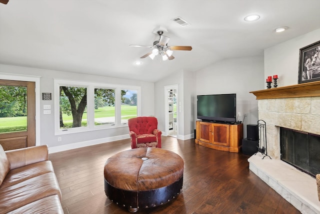 living room featuring dark hardwood / wood-style flooring, ceiling fan, a tile fireplace, and vaulted ceiling