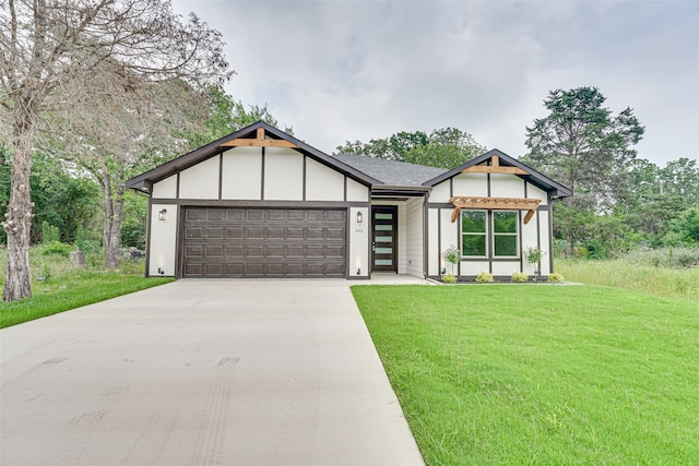 view of front of house featuring a garage and a front yard