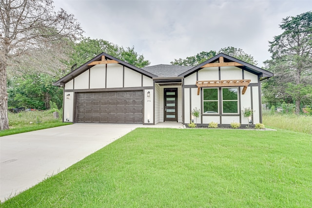 view of front of property with a front lawn and a garage