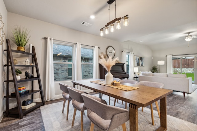 dining area with hardwood / wood-style flooring, a wealth of natural light, and ceiling fan