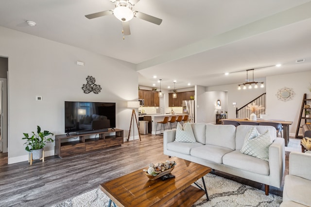 living room featuring ceiling fan and wood-type flooring