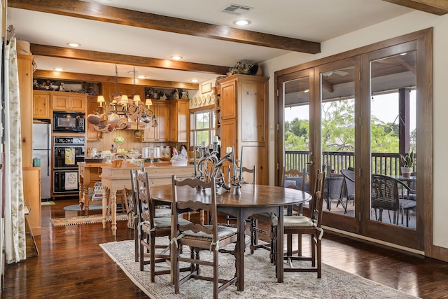 dining area with dark wood-type flooring, an inviting chandelier, and beam ceiling