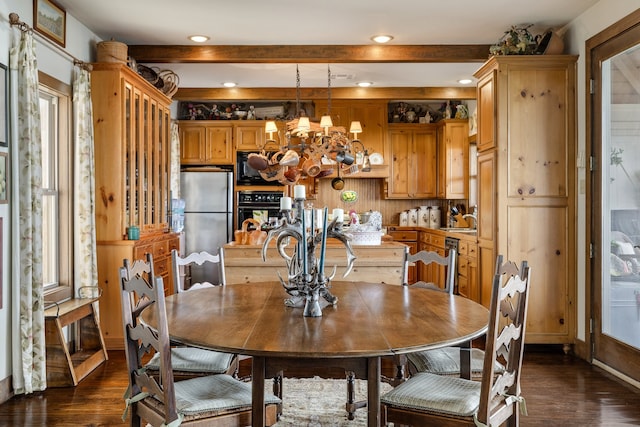 dining room featuring a chandelier, sink, and wood-type flooring