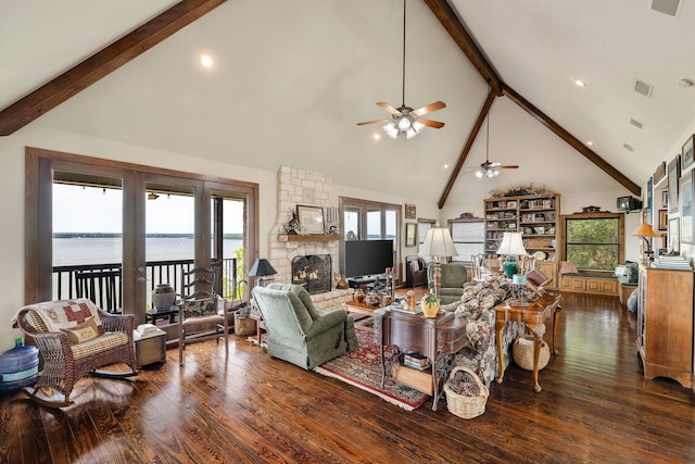 living room with high vaulted ceiling, a fireplace, ceiling fan, and dark hardwood / wood-style flooring