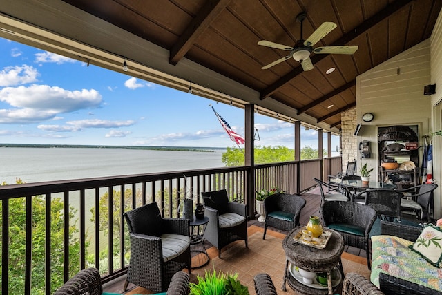 exterior space featuring ceiling fan, a water view, and an outdoor hangout area