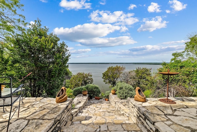 view of water feature with a fire pit