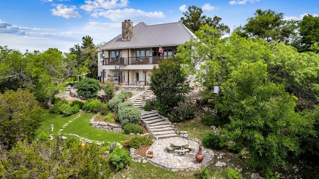 rear view of property featuring a balcony