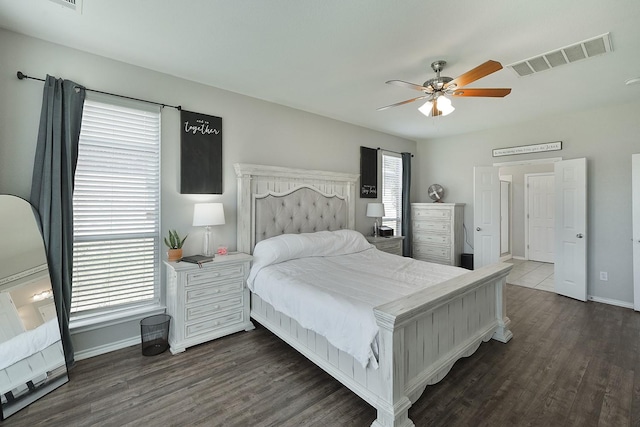 bedroom with ceiling fan and dark wood-type flooring