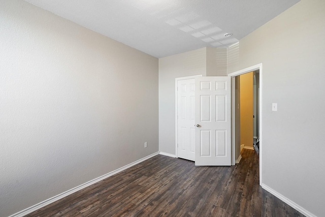 unfurnished bedroom featuring dark hardwood / wood-style floors