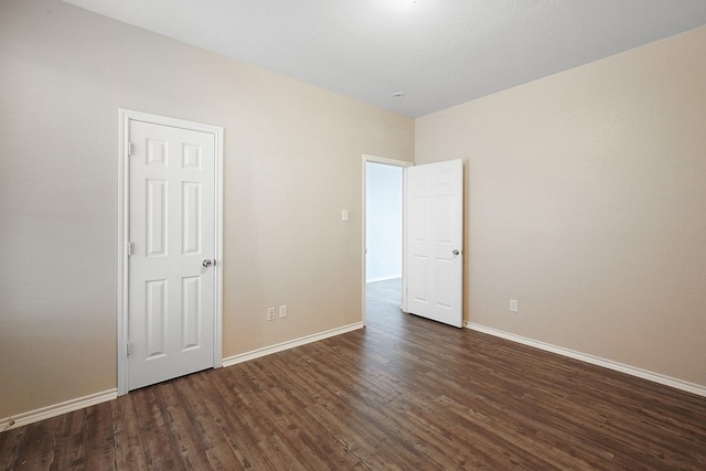 empty room featuring dark hardwood / wood-style flooring