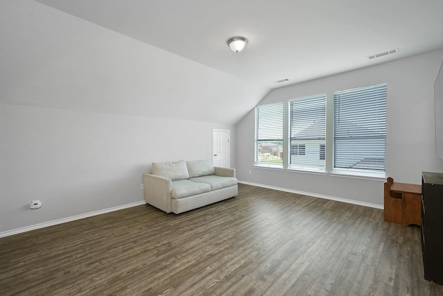 unfurnished room featuring dark hardwood / wood-style floors and lofted ceiling