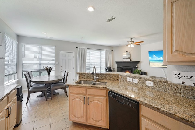 kitchen featuring light brown cabinetry, sink, plenty of natural light, and black dishwasher