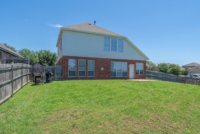 back of house with a yard